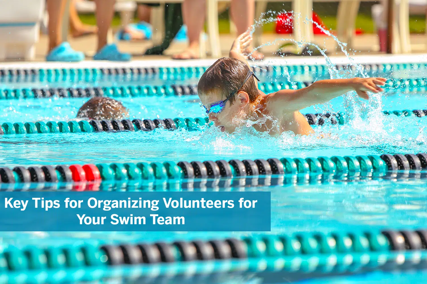 Little boy swimming in a pool with roped off lanes, competing for his swim team.