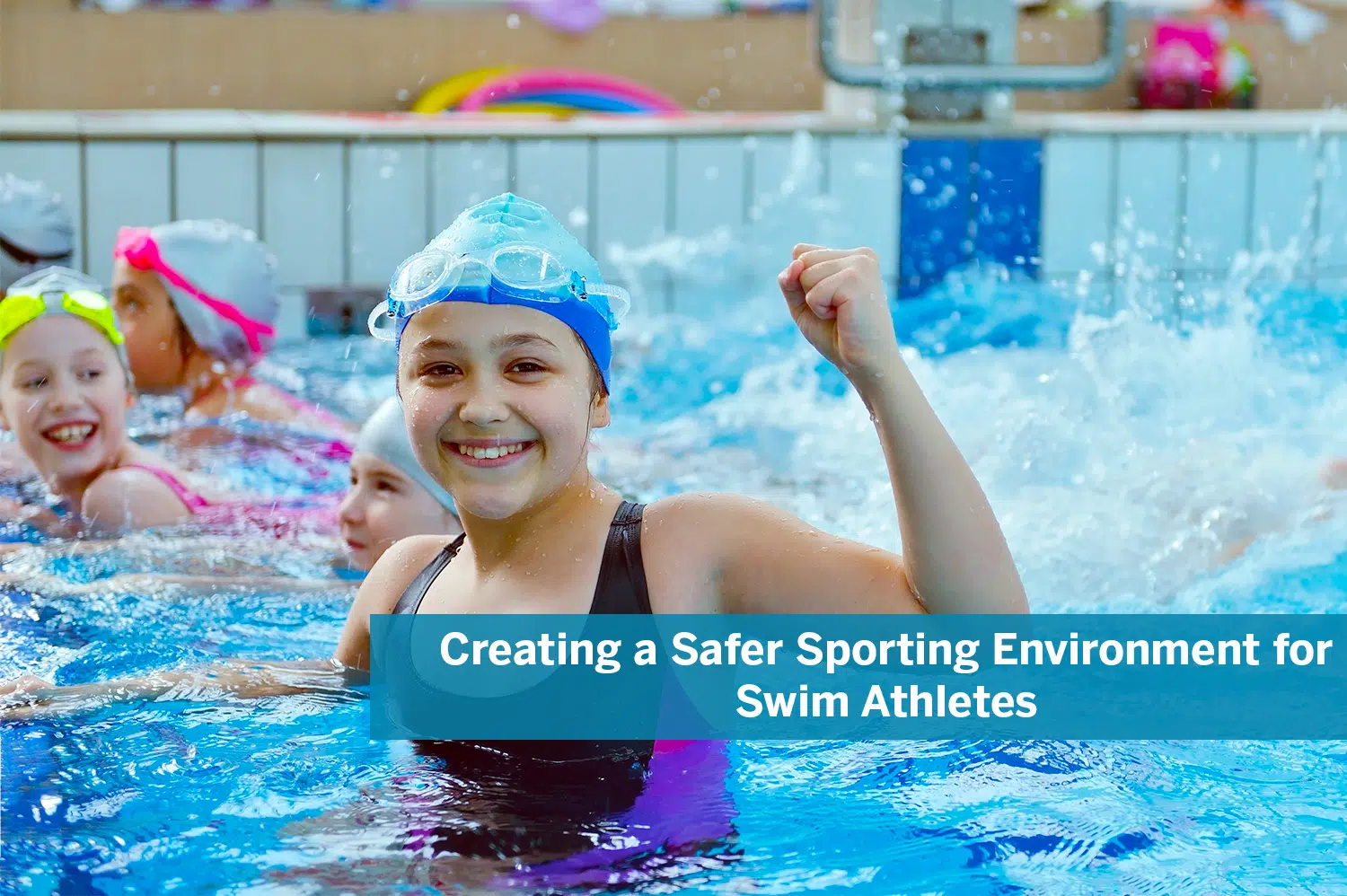 Female swim athletes in a outdoor pool, splashing around; the closest girl is wearing a blue swim cap, blue goggles, a black and purple swimsuit, and is flexing her left arm.